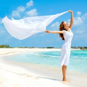 Beautiful,Girl,With,White,Scarf,Jumping,On,The,Beach.,Travel