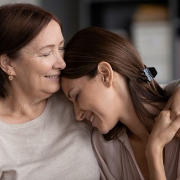 Close,Up,Smiling,Young,Woman,And,Mature,Mother,Hugging,,Elderly